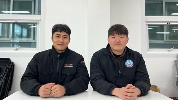 two men sitting at a table