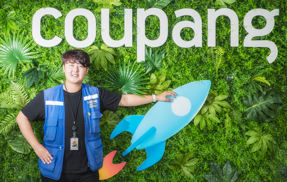 a person standing in front of a sign