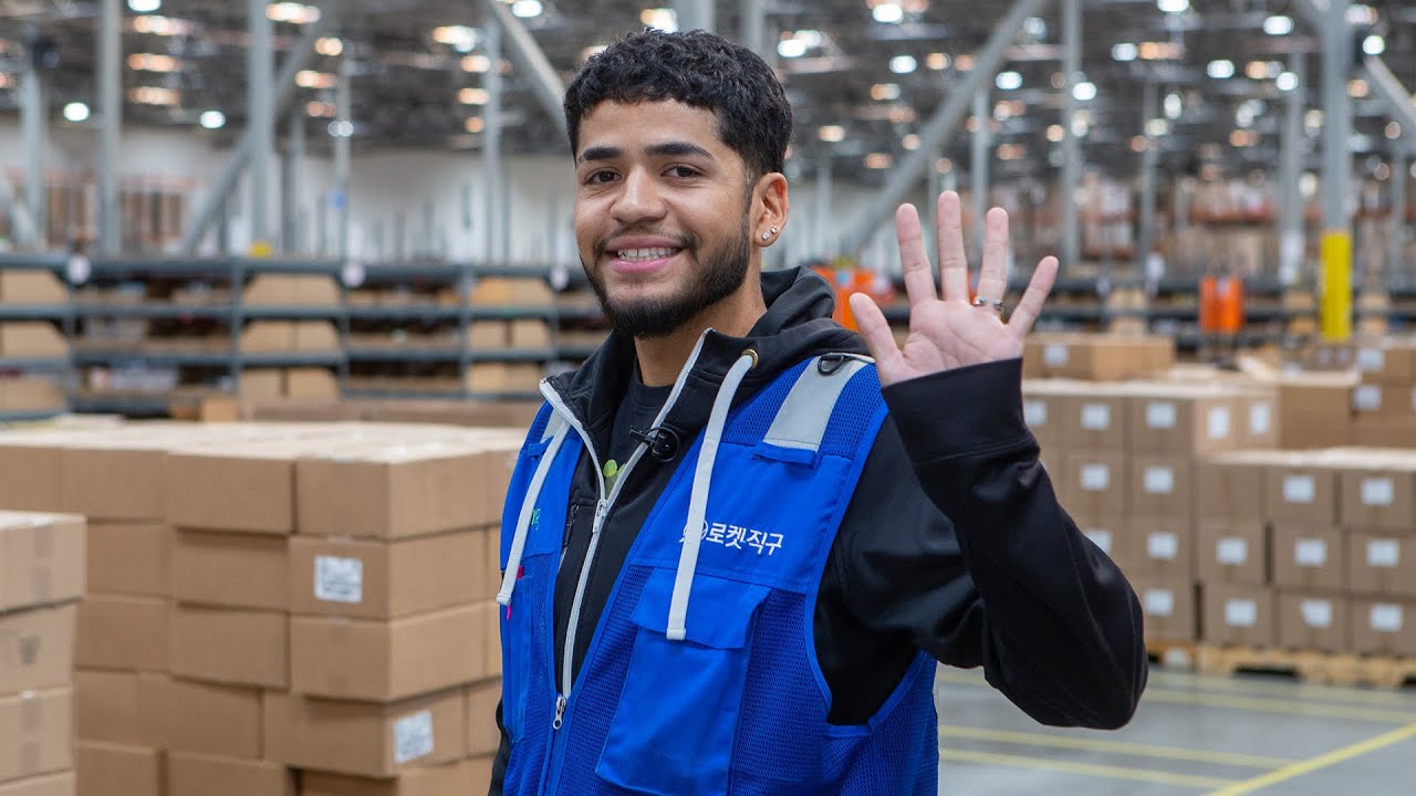 a person in a blue vest waving