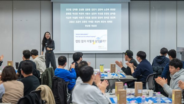 프로젝션 스크린 앞에 서 있는 사람