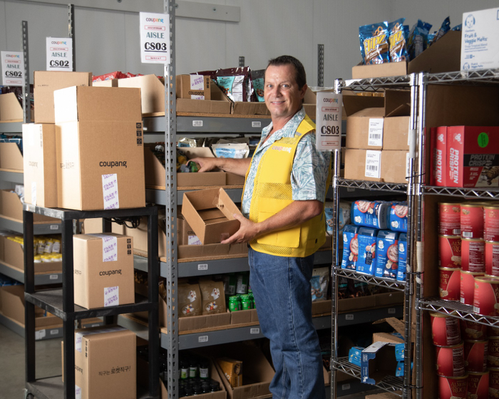 a person standing in a warehouse with boxes