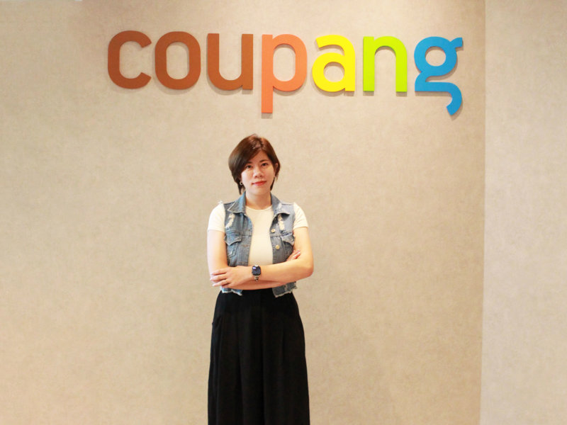 a person standing in front of a sign