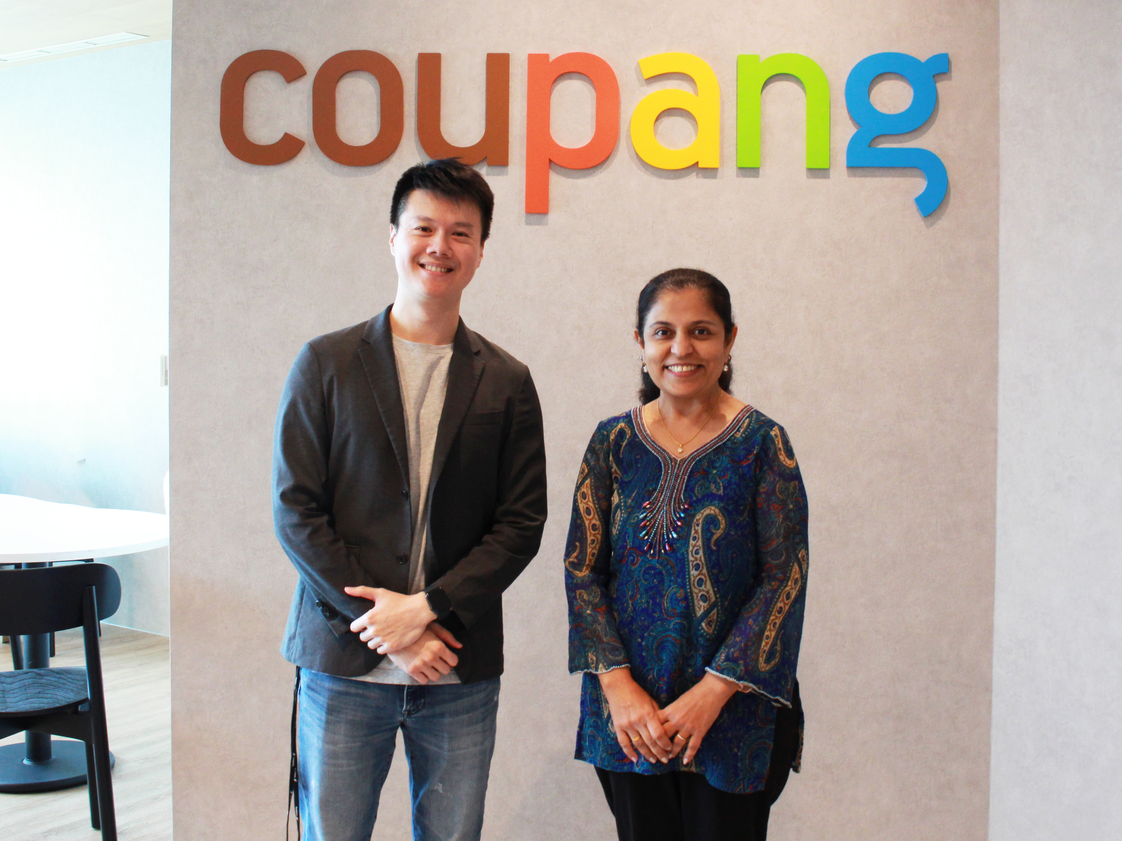 a person and person standing in front of a sign