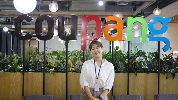 a person standing in front of a sign