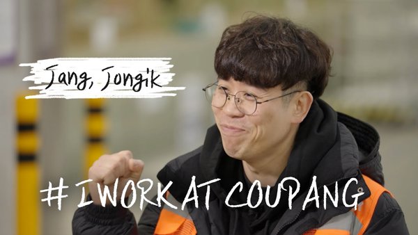 a person wearing glasses and a black jacket