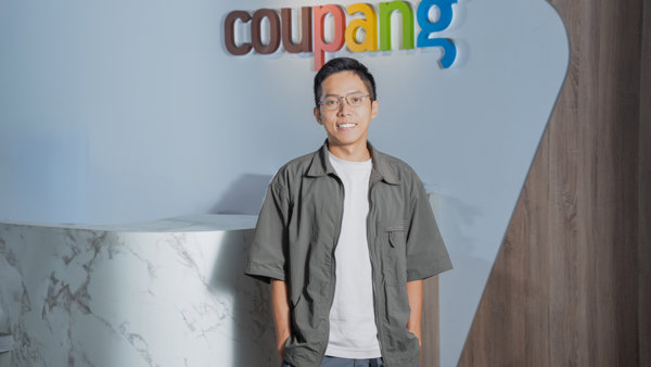 a person standing in front of a sign