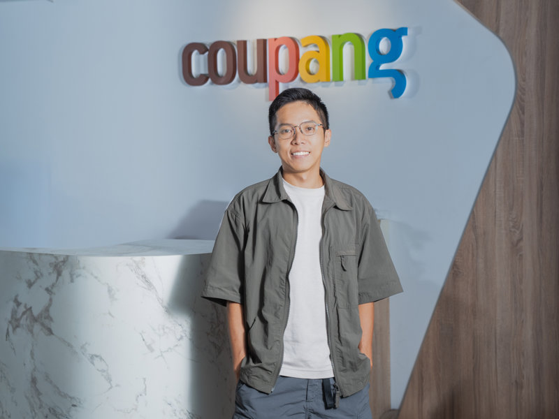 a person standing in front of a sign