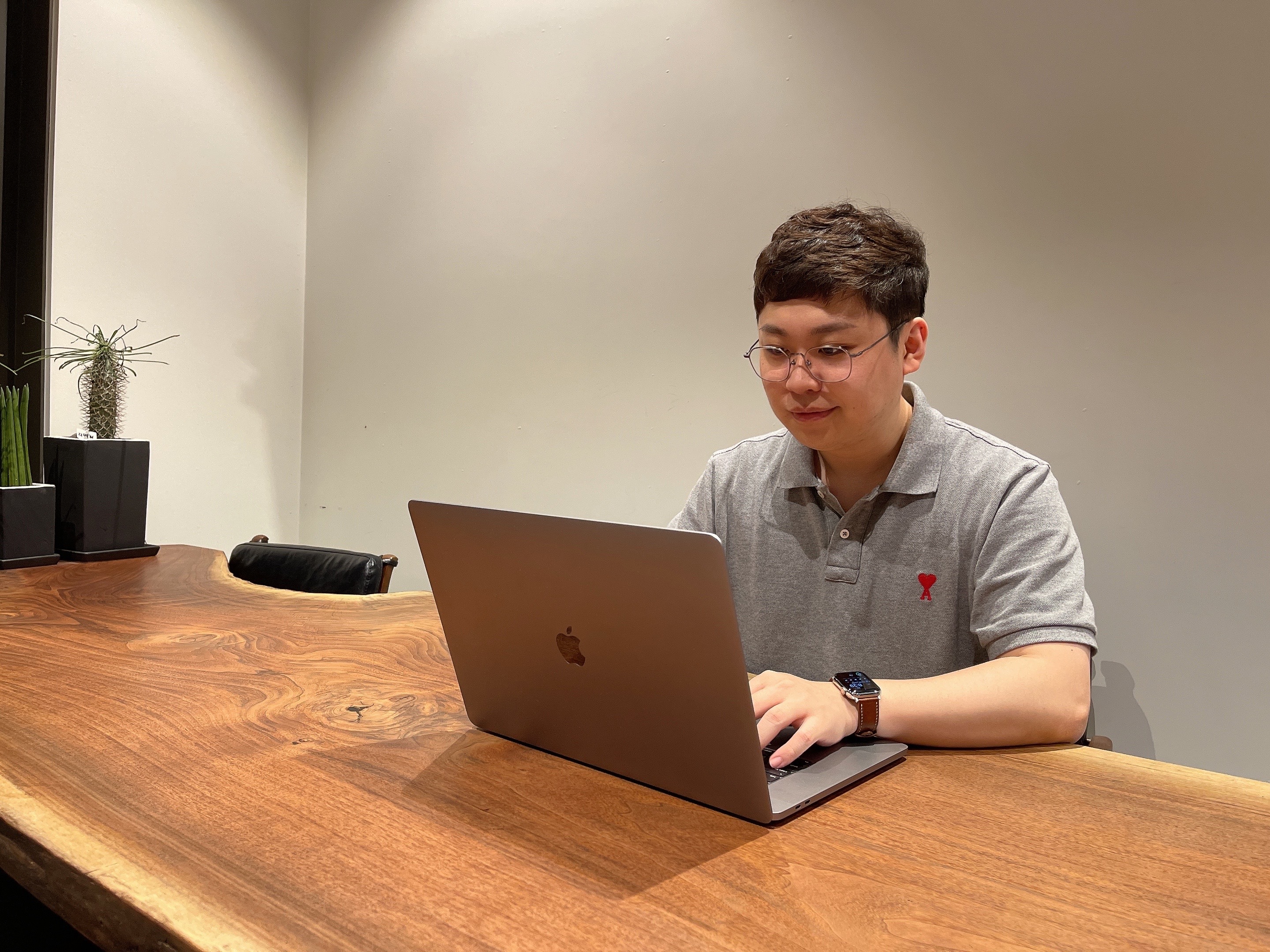 a person sitting at a table using a laptop