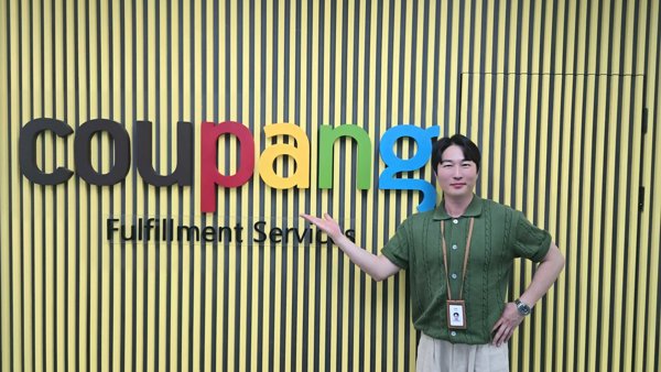 간판 앞에 서 있는 사람